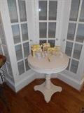 Dining Room:  One of two cream color round pedestal tables.