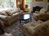 Living Room:  An ivory color CENTURY sofa; CENTURY black/gold Chinoiserie tray table; colorful rug; and two occasional chairs by HANCOCK & MOORE.