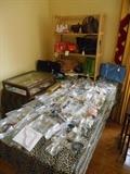 Living Room:  A nice collection of costume jewelry has been bagged.  In the background is a grouping of  purses, including a Cole Hahn, a faux Louis Vuitton Speedy 30 and an LV wallet, a Coach purse, a faux Prada and more!
