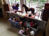 Bedroom #1:  Two American Girl doll horses; doll furniture/rugs; a tub of TY stuffed toys; doll clothing for American Girl dolls, Build-A-Bear and other dolls; and three Build-A-Bear toys.