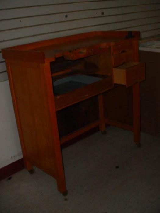 This is an artist's work desk unit, with drawers, and work spaces