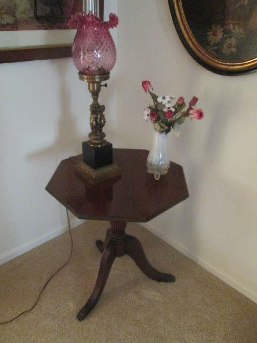 End table with nice lamp with cranberry shade