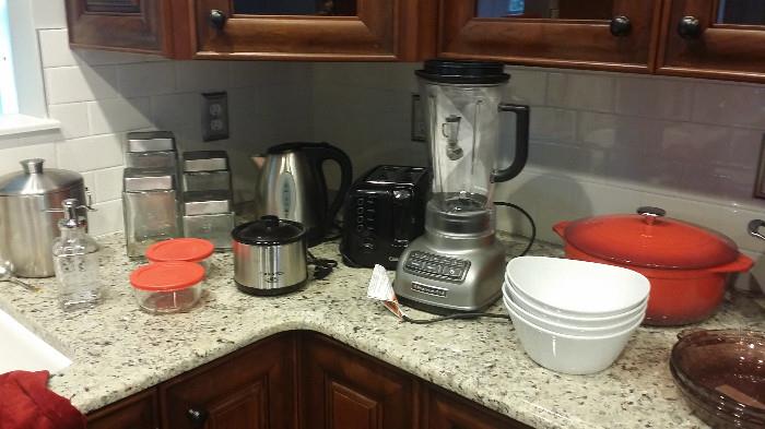 Small Kitchen Appliances, Pots and Pans, Ice Buckets, lots of food storage containers, cutting boards, and Cutco Knives 