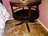 Antique embossed leather top circular pedestal table with brass gallery 