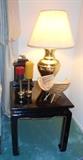 Black lacquer Asian end table with ginger style brass tone lamp and misc décor.