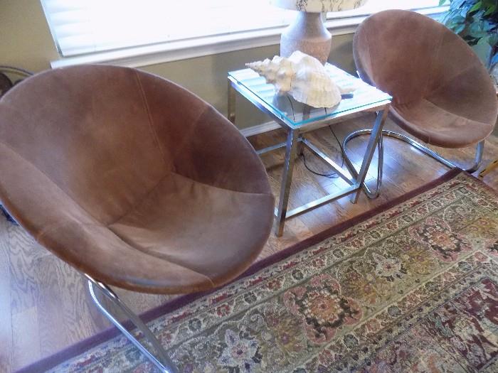 pair brown suede chrome hoop chairs and chrome/glass table