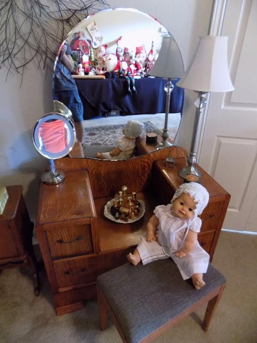 antique vanity and bench, old doll, fragrances, lamp, lighted mirror