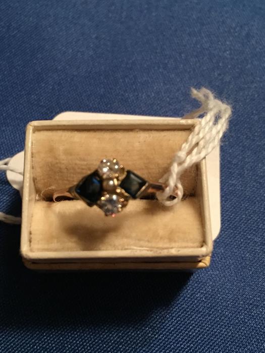 Gold diamond and sapphire ring with pearl in center.