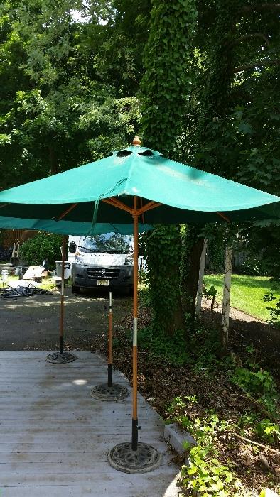 2 market umbrellas & stands….plus 3 more brand new stands