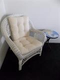 one of two white wicker chairs