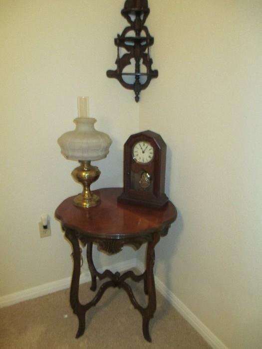 Occasional table with antique clock and electric hurricane lamp
