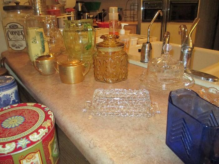 Miscellaneous including apothecary jar, large cookie jar, glass butter dish, green glass pitcher, etc..