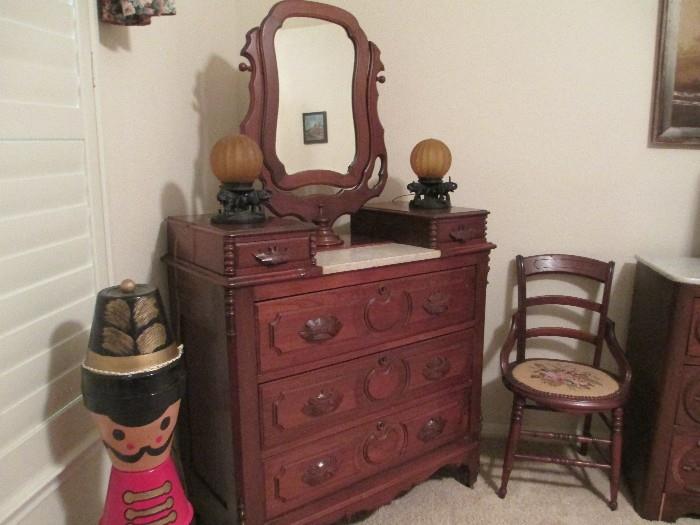 Antique dresser with mirror, marble top. Needlepoint chair. 