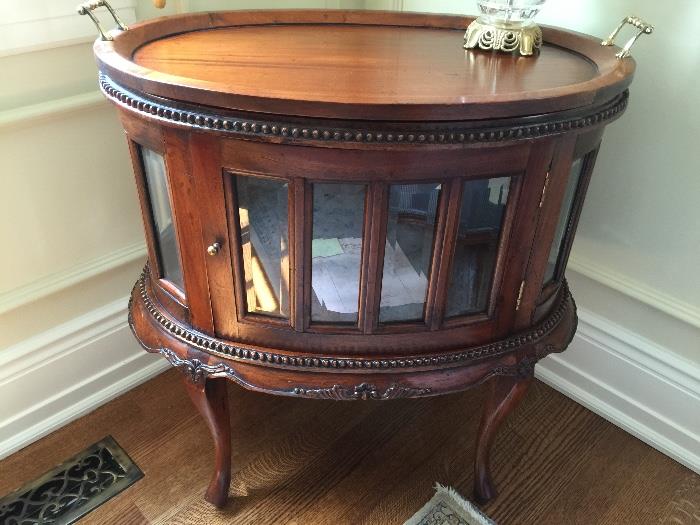 Carved mahogany tree top table w/ beveled glass sides and door