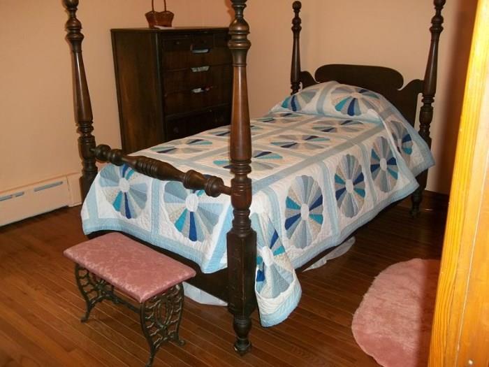 Twin poster bed on casters with Stearns & Foster mattress set