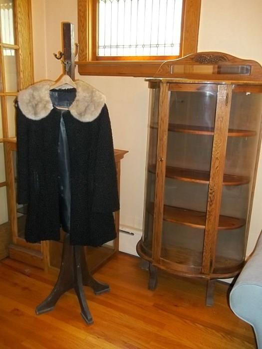 Curved glass curio cabinet and black curly lamb car coat with mink collar (has flaws).