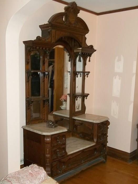 Victorian era Renaissance Revival princess dresser with drop center, marble tops and mirrored inserts.