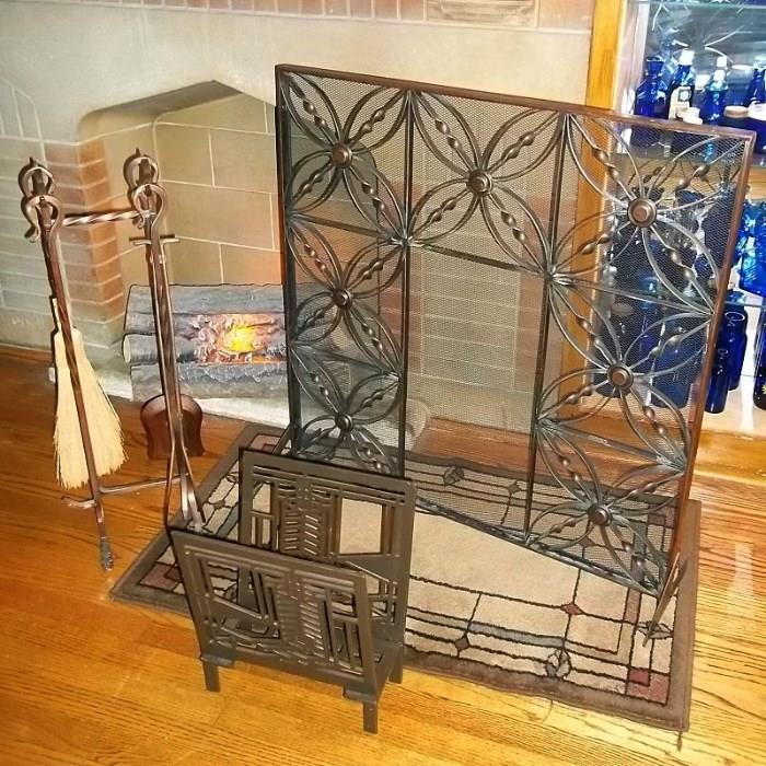 Copper (or copper-look) Arts & Crafts fireplace screen and tool set. Down front is a heavy metal magazine rack. The faux electric logs flicker.