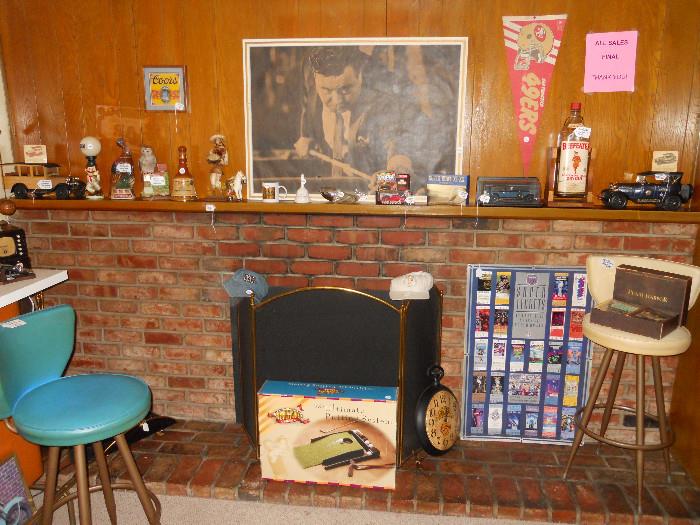 View of Mantle with Bar Collectibles, Jim Beam Whiskey Collections, Super Bowl Stubs Poster 25 Years,2 Vintage Bar Stools, Turquoise and Beige, Ultimate Putting Game, Beer Clock, Beefeater Gallon, Police Jim Beam Bottle, Jackie Gleason Poster, 49ers Pennant, Pearl Harbor Collectors Box, Coors Sign