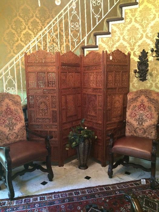 Two of six handsome arm chairs; decorative carved wooden screen; two of several lovely sconces