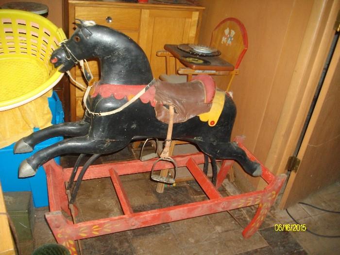 antique rocking/glider horse - high chair/stroller in the background