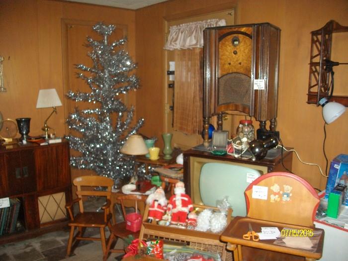 Silver Christmas tree, vintage television and radio, high chair and santas.  