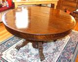 Antique claw foot tiger oak dining room table with two leaves and the protective pads.
Prominent claw feet, with casters.  Very lovely antique piece in wonderful overall condition.  this has been well cared for.