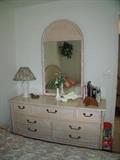 Bedroom set - dresser, wall mirror, headboard and small chest. Shade on lamp matches comforter