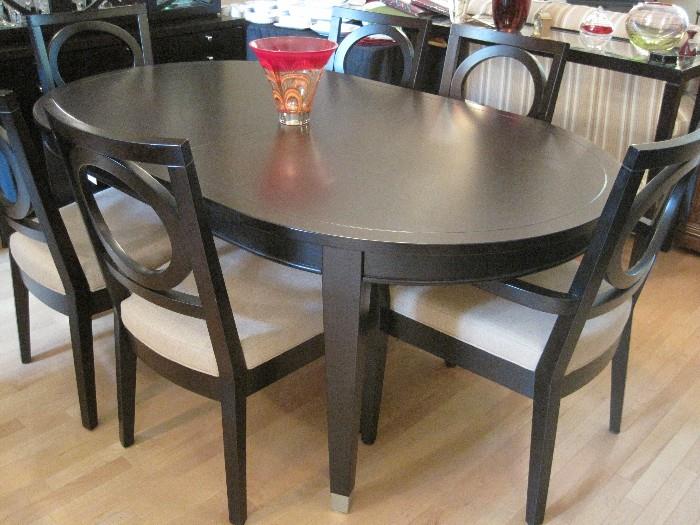 Oval shaped Ebony dining table with extra leaf, pads and 6 chairs. Waterford Evolution Vase.