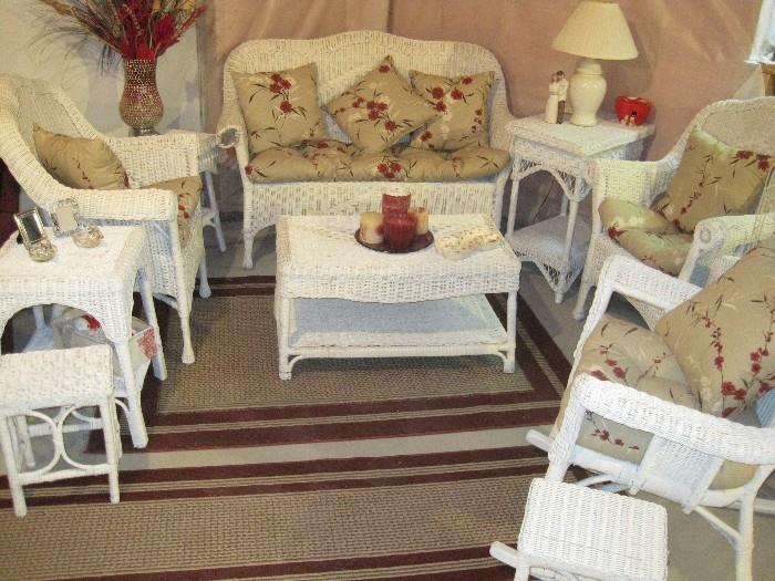 White wicker furniture, perfect summer timing! Lots of like new floor/area rugs.