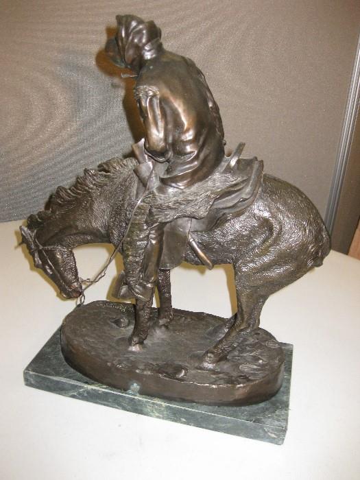 61.	Remington Bronze “Northern” Sculpture, circa 1950’s.               Pre-sale Est. $2,800
This cast bronze Remington sculpture was the first he did in the lost wax method and the 5th in his series of bronzes. Featuring the fierce winds blowing from the backside of the half frozen cowboy, shows the determination of the early man overcoming the West.  Remington never thought this would be a very popular study, and he only made 3 original casts, but has become one his most sought after works. It measures 19-3/4” high, x 18-1/8” long, and 6-7/8” wide, on marble mount.
