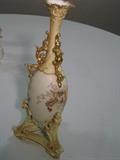 29.	Royal Rudlestodt Porcelain Vase , circa 1887        Appraisal Est. $350
Porcelain vase marked Royal Rudlestodt with RW red mark, and the bluish RW mark as well. Egg shaped porcelain container in white and blue background, with floral arrangements in various colorations. Stands on a triangular base with gold beading. 14” tall x 4-1/2” wide at the base.
