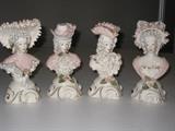 57.	Cordey China Company Porcelain Busts,. Circa 1950’s     Pre-sale Est. $125 each
(A)	Lady dressed in a shawl and bodice, highly decorated in “porcelainized lace in gold, white, blue and pinks.  #4014-P 7-1/4” tall.
(B)	Lady dressed in French high bow bonnet, again in porcelain lace of various colors. 7-1/2” tall.  #4016-P
(C)	Man dressed in Victorian “Stetson” rolled, band style hat, again with porcelain lace of the style. #4015-P.  7’ tall.
(D)	Man dressed in tri-corner hat, and again with the styled lace of various colors.#4013-P  7” tall


