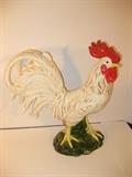 7.	American Decorative Porcelain Chicken, circa 1940.        Appraised Est. $200
Porcelain Rooster, with appropriately colored detailed body, standing in a grassy base. 14” high
