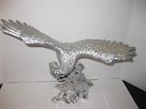72.	Cast Bronze Eagle, Silver Finish, circa 1970   Pre-sale Est. $750
This silver toned eagle, cast in bronze, is not marked, measuring 12-1/2” high & 15” wide.

