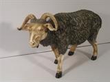 42.	Hand Carved Ivory Water Buffalo, circa 1890                     Pre-sale Est. $3,500
This rare hand carved ivory figure of a water buffalo, sits on a wooden stand. It symbolizes the second emblem of Spring and Agriculture, and the second of the symbolic animals corresponding to the 12 branches. It is considered Holy for its’ performance at the plow and the wheel. Originally from the collection of Simon Waley of London England. It has the carved features of the wooly texture, the horns, and facial expression, and is stained brown and cream. Measures 10” long, and 7-1/4” tall.
