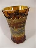 23.	Czechoslovakian “Moser” Cast and Enameled Vase, circa 1900.      Appraisal Est. $2,400
Amber glass vase of trumpet form with slightly widened base. Sides with rim and basal bands of geometric facets, and continuous medial band with painted enamel scene depicting a moving stagecoach with horse and riders. Signed, “Moser”, from Ludwig Moser and Sohne. 8-1/8” high
