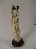 47.	Chinese Carved ivory Quan Yin, circa NA                        Pre-sale Est. $650
This is a hand carved Chinese Ivory figurine of Quan Yin, with hand upraised in blessing and holding floral. Bird ornament in her hair, and heart cartouche at her breast. Mounted on wooden stand. Measures 9” tall, 3” diameter.
