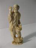 48.	Chinese ivory Peasant Figurine, circa 1940                         Pre-sale Est. $450
Great yellowish patina on this hand carved ivory peasant man, with chicken at his feet, and carrying a basket with eggs, with one in his upraised hand. Stands 4-5/8” tall
