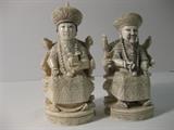 50.	Pair of Chinese Carved ivory Emperor and Empress, circa1910                      Pre-sale Est. $3,200
Identical chop marks, on the bases of these incredible carved ivory figures, identify these as matching pieces. The Emperor holds a strand of pearls of wisdom, and his throne embraces him as has the immortals on top. Dragon faces surround. The Empress has a box in her hand as well as the pearls of wisdom and is seated in an identical throne. Both are approximately 4-1/4” tall and 1-3/4” wide. 
