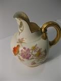 8.	Royal Worchester English Pitcher, circa 1880           Appraised Est. $575
An ovate porcelain pitcher with large vertical rim spout, and loop handles. The two sides are decorated with enamel painted floral sprays on ivory background. Gold enamel handles as well as the rim edge.  5” high. British, as marked Royal Worchester England / Rd. No. 29115/1094
