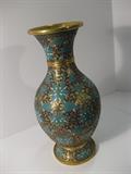 27.	Chinese, Cloisonné Vase, circa 1910.         Appraisal Est. $975
A Pyriform vase with flared mouth on a flared foot. The brass body with the enameled cloisonné patterns of green and white flowers, foliage, and butterflies, and blue interstitial scrolls. 10-1/4” high.
