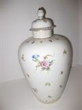 40.	French Porcelain Urn with Flowers, circa 1930                            Pre-sale Est. $280
Large porcelain urn, basic white in color, covered with hand painted florals, of many and various styles and colors, with gold accents spaced around the bulbulous shape. Lid has an acorn finial with painted florals as well around the lid. Stands 13-1/3” tall and about 7-1/2” diameter. Marked Jacob Petit, Fontainbleau, France with incised 6 over 411, #2 in red paint.
