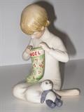 16.	Cybis Porcelain Boy with Stocking, circa 1960.           Appraisal Est. $250
Soft paste porcelain figure of a boy opening a Christmas stocking, with teddy bear at his side. 5” high. Marked CYBIS
