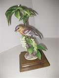 75.	Worchester Audubon Series Birds, circa 1970  Pre-sale Est. N/A
There are 8 of these high collectible porcelain birds, produced by Royal Worchester, and are highly detailed with appropriate foliage. Each comes with a wooden base, with opening to set the bird figurine in, and stand about 9-1/2” tall. We will sell these birds on a “choice” basis, with the understanding that each has some damage, chips, broken beaks, flowers, etc. , so carefully check and look at the parts and pieces we have available for repairs.
