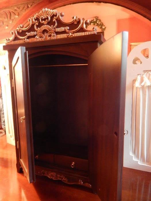 A lovely doll size armoire complete with its own hangers.