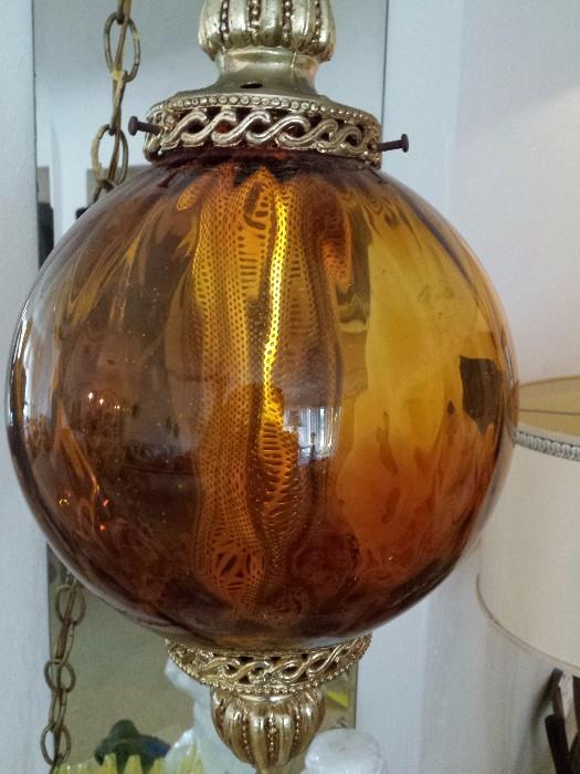 Vintage swag light with amber glass and goldtone top and bottom and chain, lights up beautifully!