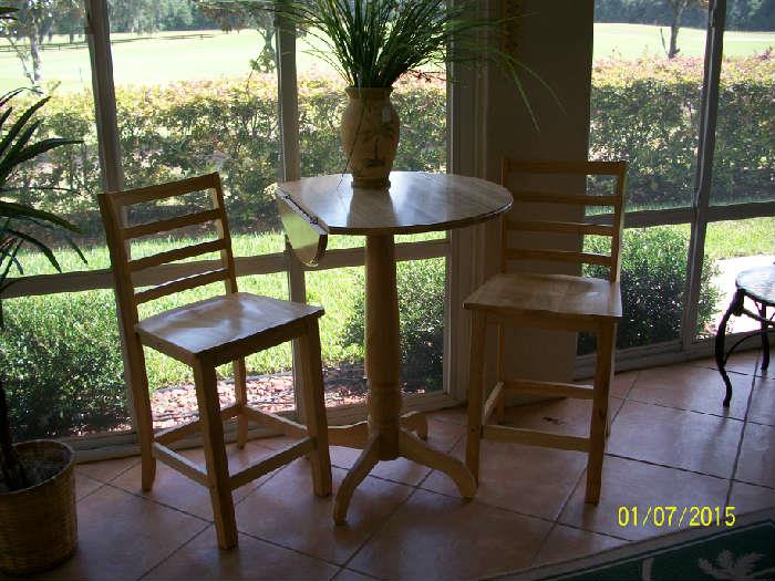 Cafe table with 2 chairs, has drop leaf sides