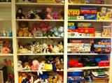 Two of many shelves filled with games and toys