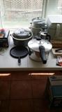 pressure cooker, pots and pans, lots of kitchen items
